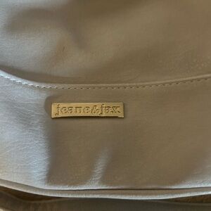 Elegant Cream Bag with Soft Material and Metallic Accent